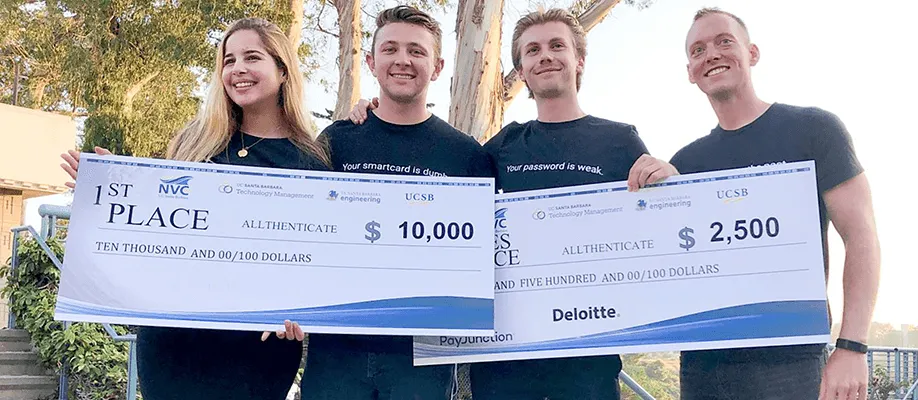 new venture competition winners accepting award check
